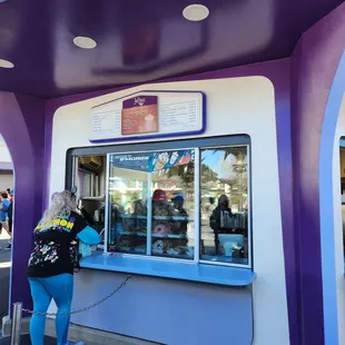 a woman standing in front of a window