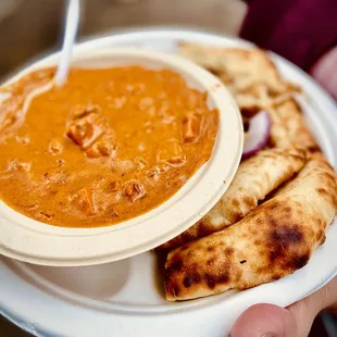 a person holding a plate of food