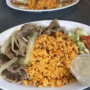Thin steak and onions with Puerto Rican Rice.