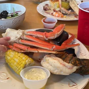a child eating crab legs and corn on the cob