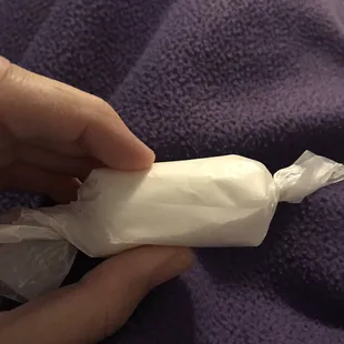 a hand holding a wrapper