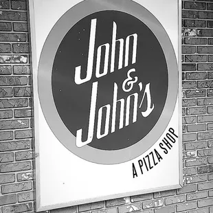 a sign on a brick wall