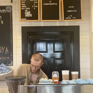 a man working in a coffee shop