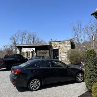 a black car parked in front of a building
