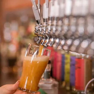 a hand holding a glass of orange juice