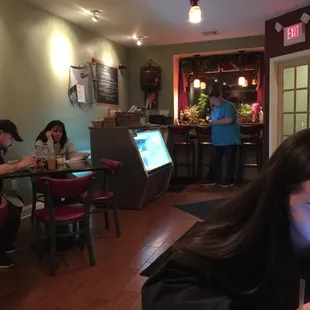 a woman sitting at a table in a restaurant