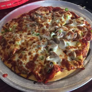 Mini combination pizza: pepperoni, sausage, green peppers, and mushrooms