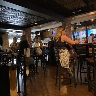a woman sitting at a bar