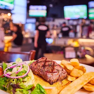 Open face Steak Sandwich served with side salad and steak fries.