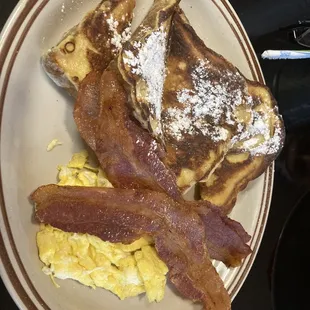 French Toast with bacon and side of scrambled egg.