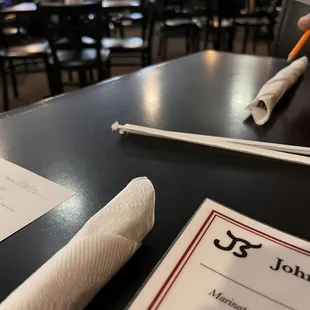 a table with a menu and chopsticks