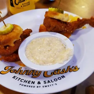 a plate of fried chicken and a bowl of sauce