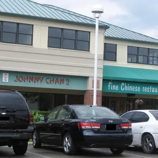 cars parked in front of a restaurant