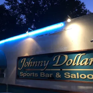 a neon sign for a sports bar and saloon
