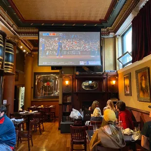 people sitting at tables in a restaurant