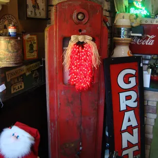 An antique gas pump with light-up chili peppers (not antique).