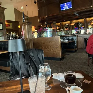 a woman sitting at a table in a restaurant