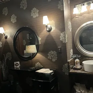 a woman taking a selfie in a bathroom mirror