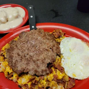 Homemade  Sausage egg and potatoes with biscuits and gravy those potatoes are loaded with bacon and cheese.