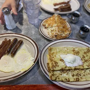 a breakfast of eggs, bacon and pancakes