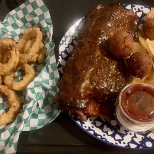 Slow smoked wet ribs, homemade chips, double breaded onion rings, with a side of hush puppies.