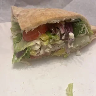 a sandwich with lettuce and tomatoes