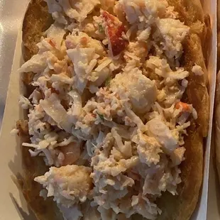 two pizzas in a styrofoam container