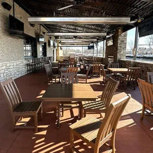 Spacious Patio with a Fireplace and Window Access to the Main Bar Inside