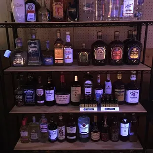 a shelf full of liquor bottles