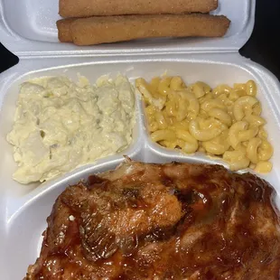 Bbq ribs with Mac and cheese, potatoes salad and corn sticks