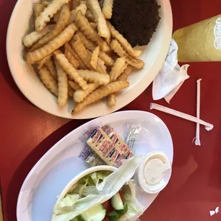 Hamburger steak plate with two sides that are fries and salad. Great portion sizes and food.