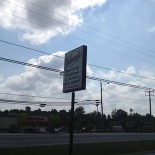 Road Sign - claims "Pit-Cooked Daily, assumes that excludes the Seafood &amp; Steaks.