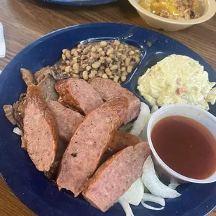 Sausage and Beef plate with collard greens and potato salad. So good!