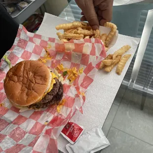 Double cheeseburger w/ fries plus my husband&apos;s hand