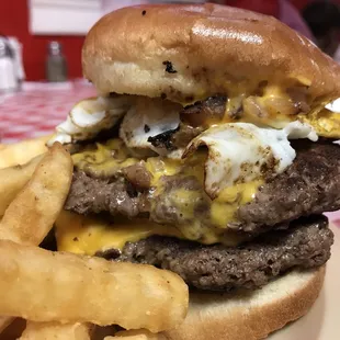 Double cheese burger with bacon and a fried egg.