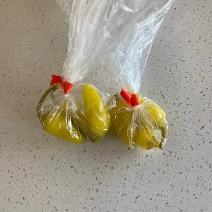 three bags of pickles wrapped in plastic