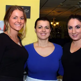 three women smiling for the camera