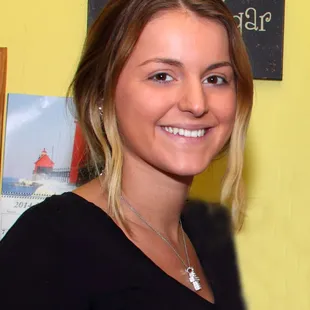 a smiling woman in a black shirt