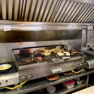 a grill with food cooking on it