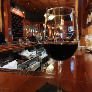 a glass of wine on a bar