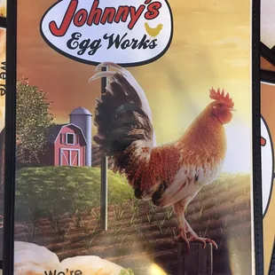 a chicken standing on a post