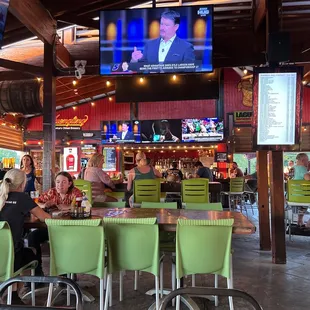 eople sitting at tables in a restaurant
