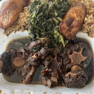 Oxtails with rice, greens, and plantains.