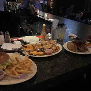 Also pictured: half slab bbq baby back ribs, half a chicken, a baked potato, and mixed veggies