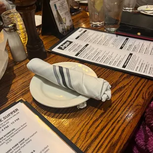 a table with a menu and a napkin