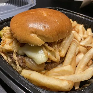 Cadillac burger with sautéed onions and fries