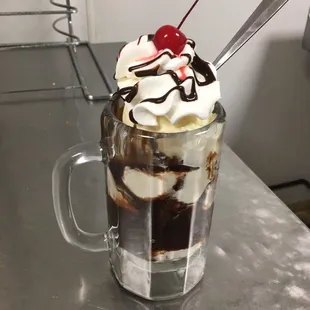 a chocolate sundae with whipped cream and a cherry on top
