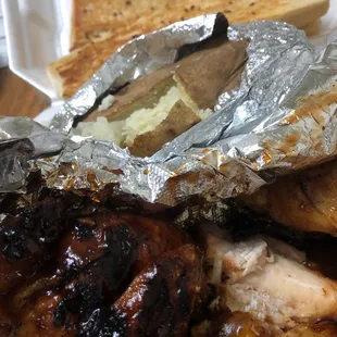 BBQ half chicken, garlic bread, a baked potatoe