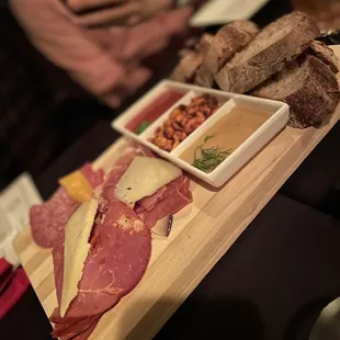 a platter of meats and breads