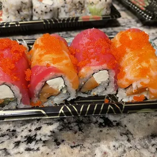a plate of sushi rolls
